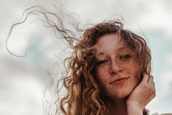 a woman with freckled hair is posing for a picture